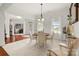 Cozy dining room with a round table, stylish chandelier, and ample natural light at 2399 Ashbourne Se Pl, Concord, NC 28025