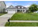 Charming single-Gathering home featuring a well-manicured lawn and an attached two-car garage at 2399 Ashbourne Se Pl, Concord, NC 28025