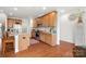 Well-lit kitchen features stainless steel appliances, wood cabinets, granite countertops, and a functional kitchen island at 2399 Ashbourne Se Pl, Concord, NC 28025