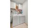 Neat laundry room equipped with washer, dryer, shelving, and storage cabinets at 2399 Ashbourne Se Pl, Concord, NC 28025