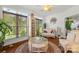 Cozy, sunlit living room with large windows, wicker furniture, and hardwood floors at 2399 Ashbourne Se Pl, Concord, NC 28025