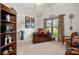 Inviting home office with custom desk, natural light, and ample shelf space at 2399 Ashbourne Se Pl, Concord, NC 28025