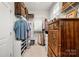 Spacious walk-in closet with custom shelving and a dresser at 2399 Ashbourne Se Pl, Concord, NC 28025