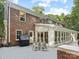 Brick home's rear exterior featuring a spacious deck, patio, and sunroom at 2432 Hartmill Ct, Charlotte, NC 28226