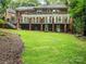 Expansive backyard with lush lawn and multi-level brick home exterior at 2432 Hartmill Ct, Charlotte, NC 28226