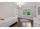This bedroom features hardwood floors, neutral paint, and a window view of lush greenery at 2432 Hartmill Ct, Charlotte, NC 28226