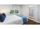 This bedroom boasts hardwood floors, a Queen bed, and a view of the lush trees outside at 2432 Hartmill Ct, Charlotte, NC 28226