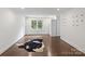 This bonus room boasts hardwood floors, neutral paint, and a view of the lush trees outside at 2432 Hartmill Ct, Charlotte, NC 28226