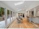 Bright dining area with large windows, hardwood floors, and access to the kitchen at 2432 Hartmill Ct, Charlotte, NC 28226
