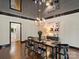Elegant dining room featuring a modern chandelier, black table setting, and hardwood floors at 2432 Hartmill Ct, Charlotte, NC 28226
