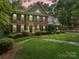 Traditional brick two-story home featuring a well-manicured front yard and symmetrical window placement at 2432 Hartmill Ct, Charlotte, NC 28226