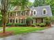 Charming two-story brick home with mature landscaping, black shutters, and a gray roof at 2432 Hartmill Ct, Charlotte, NC 28226