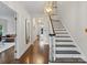 Bright foyer with hardwood floors, elegant staircase, and stylish lighting fixture at 2432 Hartmill Ct, Charlotte, NC 28226