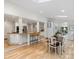 Open concept kitchen with granite countertops, white cabinets, an island, and hardwood floors at 2432 Hartmill Ct, Charlotte, NC 28226