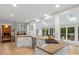 Bright kitchen features white cabinets, granite countertops, an island with a cooktop, and stainless steel appliances at 2432 Hartmill Ct, Charlotte, NC 28226