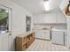 Clean laundry room with white cabinets, tile flooring, and washer/dryer at 2432 Hartmill Ct, Charlotte, NC 28226