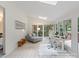 Cozy living room features a seating area, desk, large windows, and access to the outdoors at 2432 Hartmill Ct, Charlotte, NC 28226