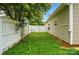 The side yard includes grass, a privacy fence, and side access to the house at 2723 Craddock Ave, Charlotte, NC 28208
