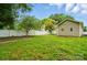 Grassy backyard featuring a white fence, mature trees, and a level lot at 2723 Craddock Ave, Charlotte, NC 28208