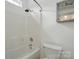 This bathroom features a shower and tub combination with white tile and modern fixtures at 2723 Craddock Ave, Charlotte, NC 28208