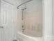 This bathroom features a shower and tub combination with white tile and modern fixtures at 2723 Craddock Ave, Charlotte, NC 28208