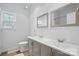 Bathroom with double vanity, framed mirrors, tiled floors and a window offering plenty of natural light at 2723 Craddock Ave, Charlotte, NC 28208