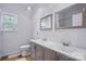 Bathroom boasts double sink vanity, large mirrors, toilet and window at 2723 Craddock Ave, Charlotte, NC 28208