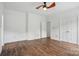 Bright bedroom with a ceiling fan, hardwood floors, a closet and access to another room at 2723 Craddock Ave, Charlotte, NC 28208