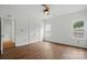 Bright bedroom features a ceiling fan, wood flooring, and a double closet for ample storage at 2723 Craddock Ave, Charlotte, NC 28208