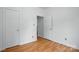 This bedroom features hardwood floors, white walls, and bright lighting at 2723 Craddock Ave, Charlotte, NC 28208