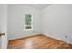 Bright bedroom with hardwood floors, window, and neutral walls at 2723 Craddock Ave, Charlotte, NC 28208
