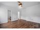 Bedroom boasts hardwood floors, ceiling fan, closet and white paint with ensuite bathroom at 2723 Craddock Ave, Charlotte, NC 28208