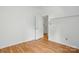 Bedroom with wood floors, light-colored walls, and an open doorway at 2723 Craddock Ave, Charlotte, NC 28208