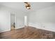Spacious bedroom featuring hard wood floors, neutral walls and access to multiple rooms at 2723 Craddock Ave, Charlotte, NC 28208