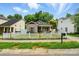 Charming single-story home with white picket fence, red trim, and cozy curb appeal at 2723 Craddock Ave, Charlotte, NC 28208