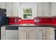 Bright kitchen featuring stainless steel dishwasher, sink, and cabinetry at 2723 Craddock Ave, Charlotte, NC 28208