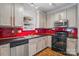Functional kitchen with stainless steel appliances, ample cabinetry, and a red backsplash at 2723 Craddock Ave, Charlotte, NC 28208