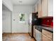 Bright kitchen with stainless steel refrigerator and dishwasher, plus door to outside at 2723 Craddock Ave, Charlotte, NC 28208