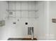 Functional laundry area with built in shelving and neutral walls, offering extra storage at 2723 Craddock Ave, Charlotte, NC 28208