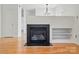 A cozy living room with hardwood floors, fireplace, and built-in shelving at 2723 Craddock Ave, Charlotte, NC 28208