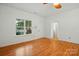 Bright living room with hardwood floors, large window, and neutral paint at 2723 Craddock Ave, Charlotte, NC 28208