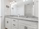 Well-lit bathroom features a double vanity with framed mirrors, granite countertops, and modern fixtures at 2732 Berkhamstead Cir, Concord, NC 28027