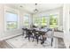 Sunlit dining area with large windows and stylish rug creates a cozy space for meals at 2732 Berkhamstead Cir, Concord, NC 28027