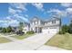 Traditional two-story home with a three-car garage, well-maintained landscaping, and neutral exterior at 2732 Berkhamstead Cir, Concord, NC 28027