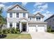 Beautiful two-story home featuring a well-manicured lawn, gray siding and a two-car garage at 2732 Berkhamstead Cir, Concord, NC 28027