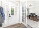 Inviting foyer with wood floors, showcasing an office through a glass French door at 2732 Berkhamstead Cir, Concord, NC 28027