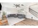 Cozy living room features a gray sectional sofa, hardwood floors, and a photo gallery wall at 2732 Berkhamstead Cir, Concord, NC 28027
