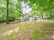 Scenic view of the backyard with lush greenery and mature trees, offering privacy and tranquility at 3051 Dairy Farm Dr, Monroe, NC 28110