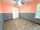 An empty bedroom with laminate floors, a ceiling fan, and light streaming in from the window at 3051 Dairy Farm Dr, Monroe, NC 28110