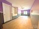 View of the empty, brightly painted room featuring a ceiling fan and a bathroom with a tub at 3051 Dairy Farm Dr, Monroe, NC 28110
